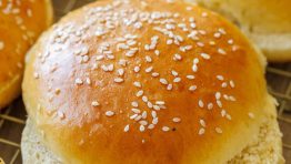 Cut homemade hamburger buns with sesame seeds