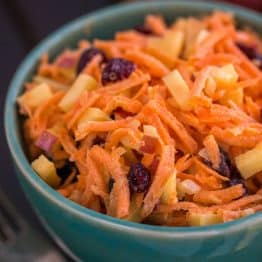 A close up of a bowl of carrot and apple salad