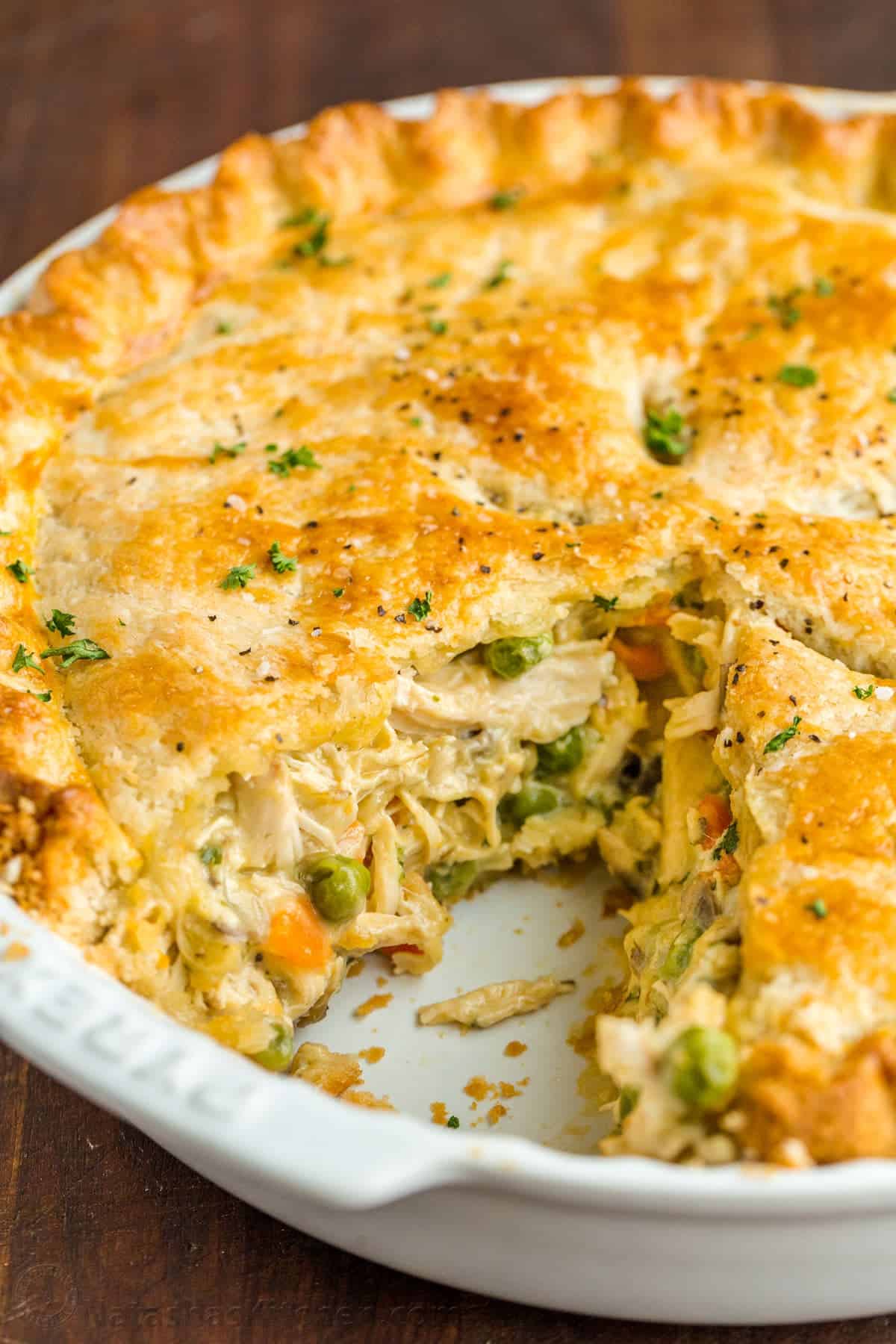 Chicken Pot Pie Recipe with a flaky crust, filled with juicy chicken and veggies in gravy. Homemade Chicken Pot Pie is a classic comfort food. Sliced chicken pot pie with chicken and veggie center