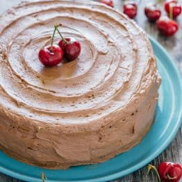 Decadent but simple chocolate cherry cake. Kirsch and cherries amplify chocolate in an intense and delicious way. The moist filling in this chocolate cake will surprise you! | natashaskitchen.com