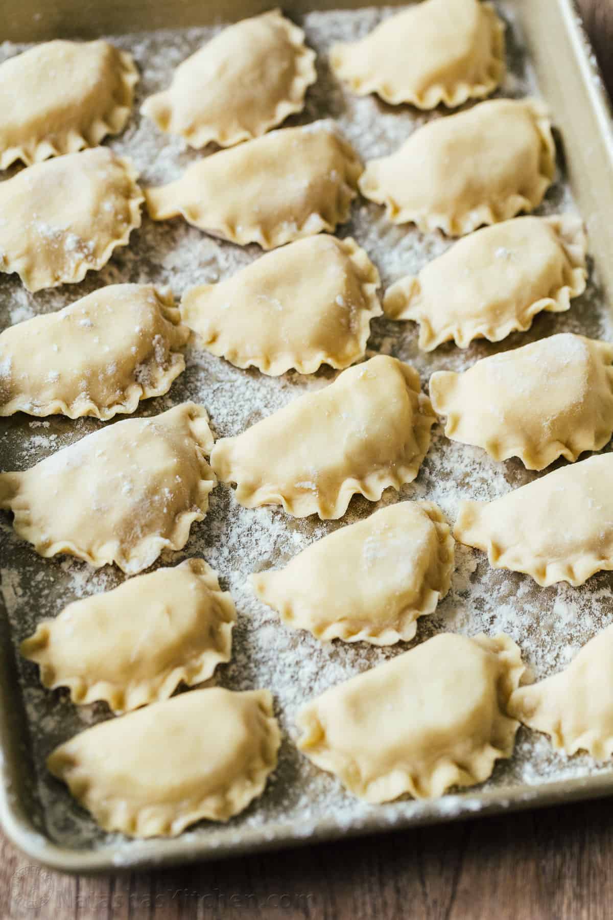 Pierogi filled with cheesy potatoes and served with crisp bacon, melted butter and sour cream. Homemade Pierogi is the ultimate comfort food! how to freeze pierogi on a sheetpan