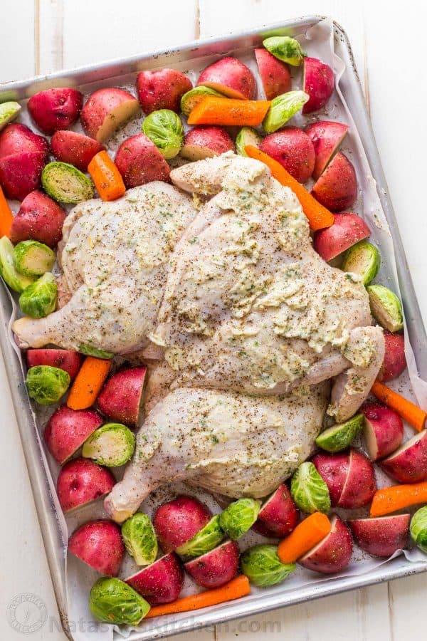 This Spatchcock chicken recipe is our favorite way to roast a whole chicken. Every part of the roasted chicken turns out juicy and so flavorful with that garlic herb butter. Easy and delicious one pan chicken dinner!