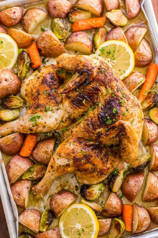 This Spatchcock chicken recipe is our favorite way to roast a whole chicken. Every part of the roasted chicken turns out juicy and so flavorful with that garlic herb butter. Easy and delicious one pan chicken dinner! 