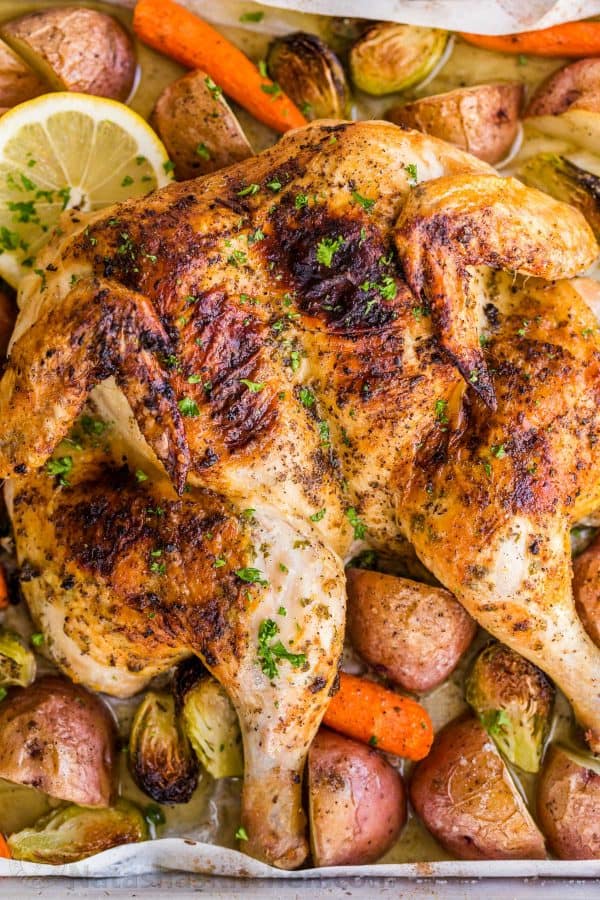 This Spatchcock chicken recipe is our favorite way to roast a whole chicken. Every part of the roasted chicken turns out juicy and so flavorful with that garlic herb butter. Easy and delicious one pan chicken dinner! | natashaskitchen.com