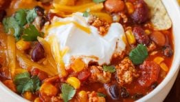 Bowl of the best turkey chili recipe with tortilla chips on the side